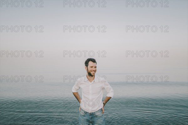 Caucasian man standing near ocean