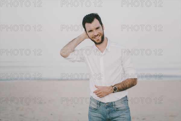 Caucasian man standing on beach