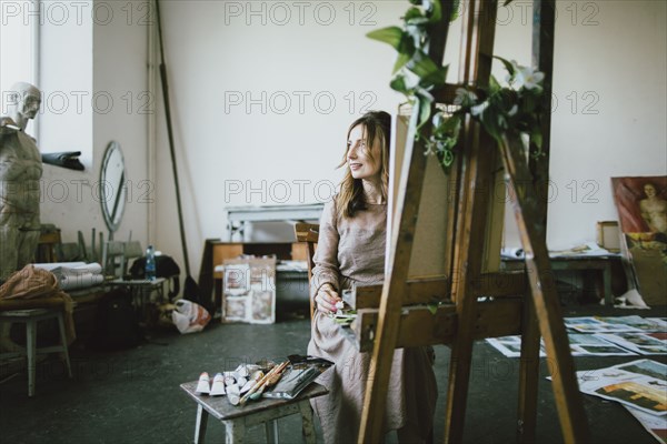 Caucasian woman painting in studio