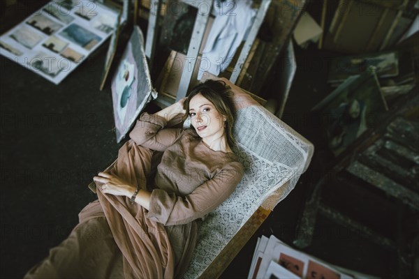 Smiling Caucasian woman laying on chaise longue