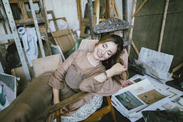 Smiling Caucasian woman laying in chair