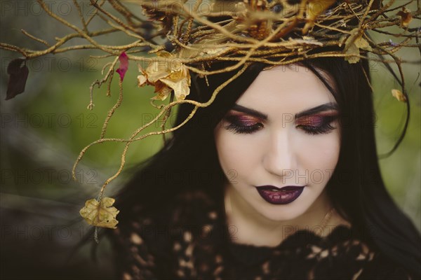 Gothic Caucasian woman wearing crown of branches