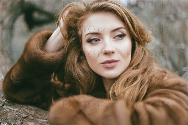 Portrait of smiling Caucasian woman wearing fur coat