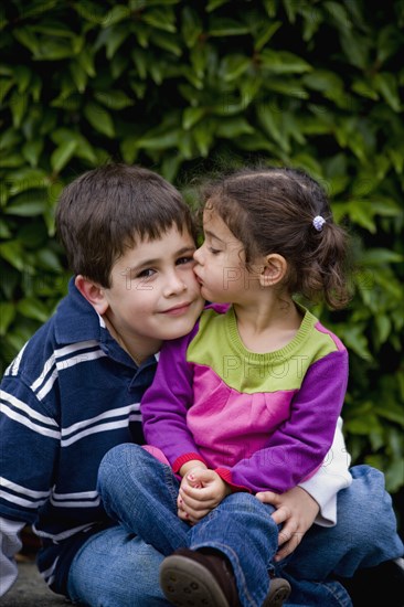 Sister kissing brother