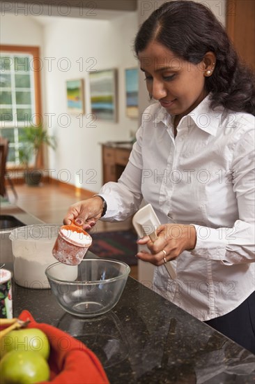 Indian woman baking in kitchen