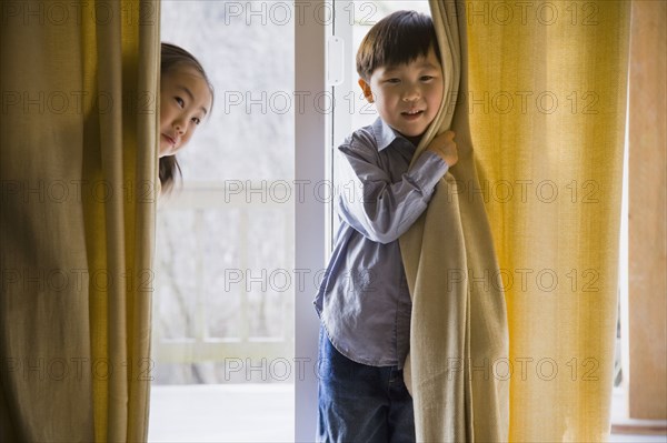 Korean children behind curtains