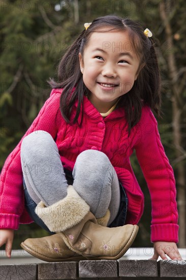 Korean girl sitting on picnic bench