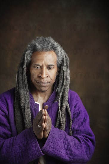 African man with dreadlocks praying