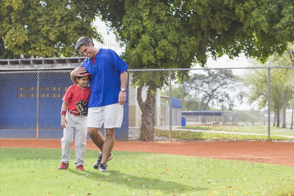 Hispanic coach and young baseball player