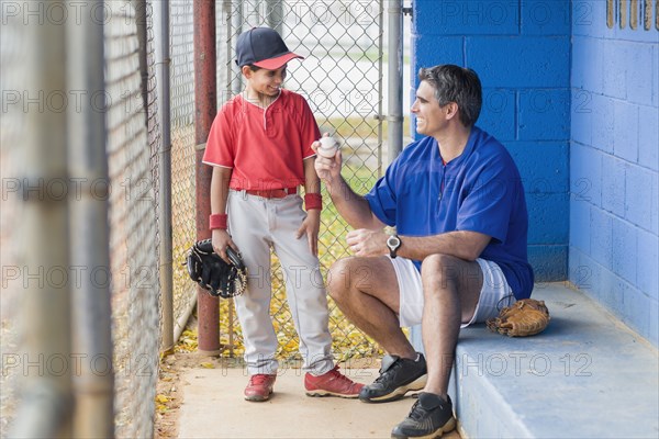 Hispanic coach and young baseball player