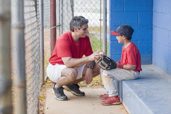 Hispanic coach and young baseball player