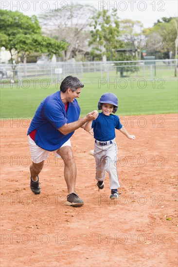 Hispanic coach and young baseball player