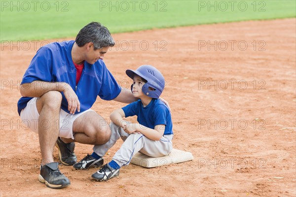 Hispanic coach and young baseball player