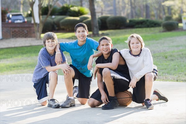 Boys sitting with basketball