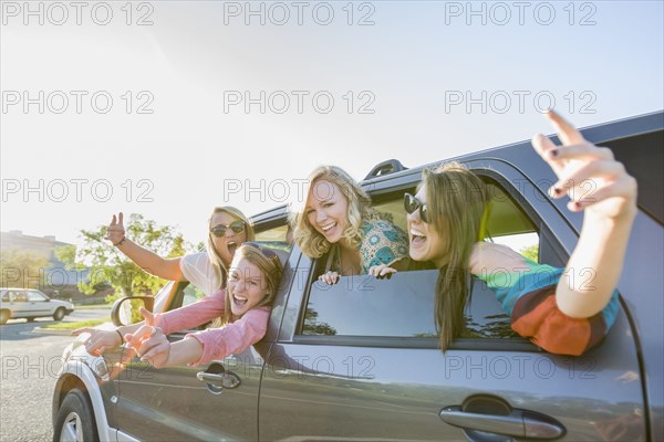 Playful friends in car