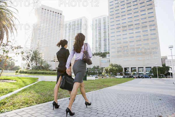 Hispanic businesswomen walking together