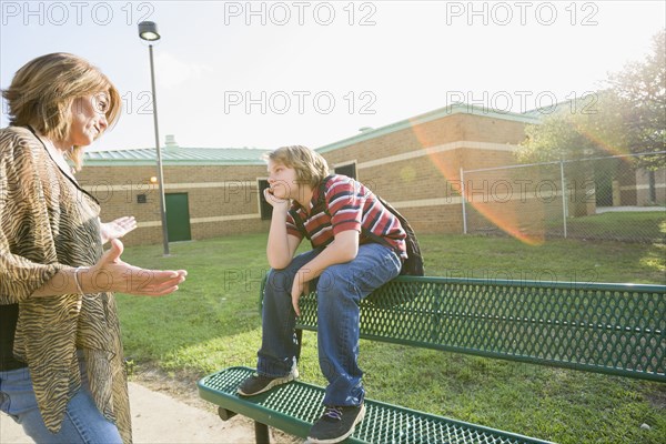 Caucasian mother lecturing son