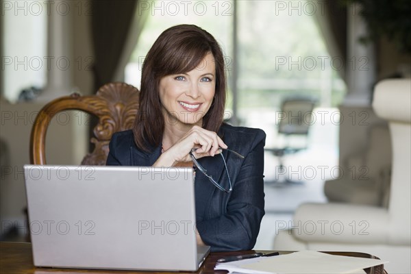 Caucasian businesswoman working on laptop