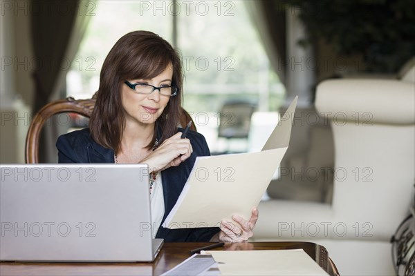 Caucasian businesswoman looking at paperwork