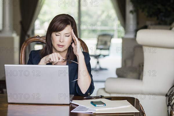 Caucasian businesswoman with headache