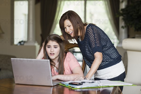 Caucasian mother helping daughter with homework