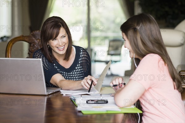 Caucasian mother helping daughter with homework