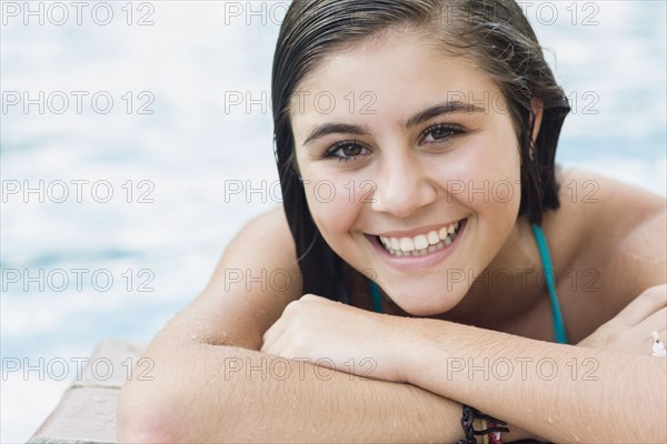 Smiling Caucasian teenager at poolside