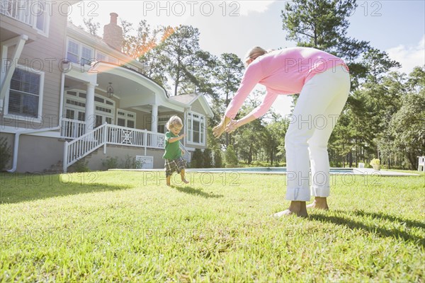 Caucasian mother and son playing in backyard