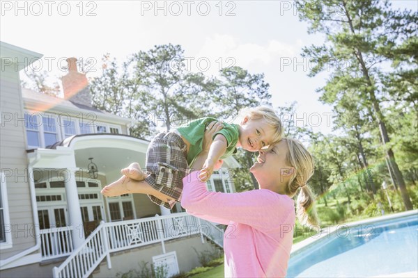 Caucasian mother and son playing in backyard