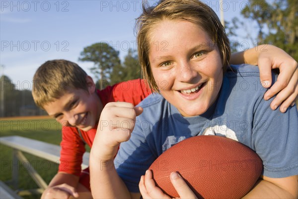 Caucasian boys holding football