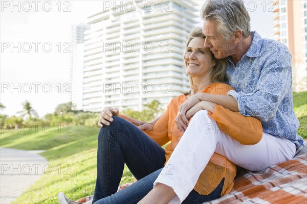 Caucasian couple relaxing in city park