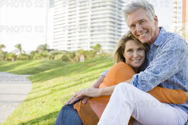 Caucasian couple relaxing in city park