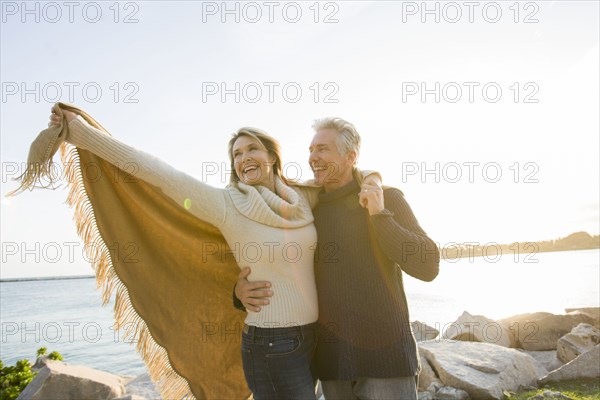 Caucasian couple walking by lake