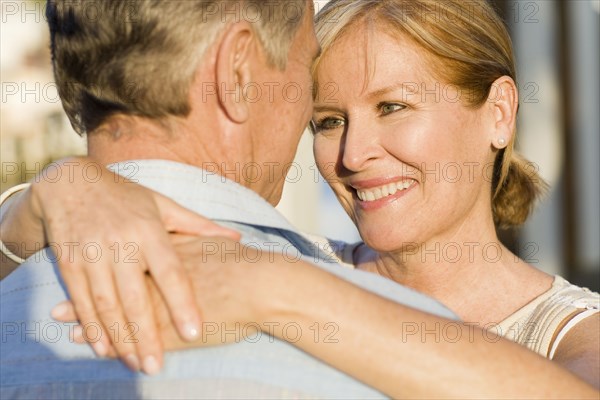 Caucasian couple hugging outdoors