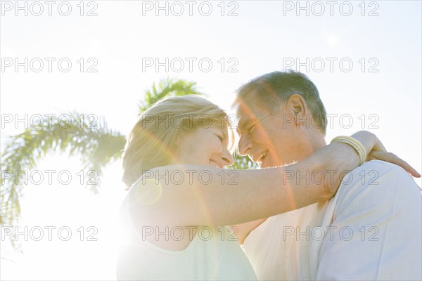 Caucasian couple hugging outdoors