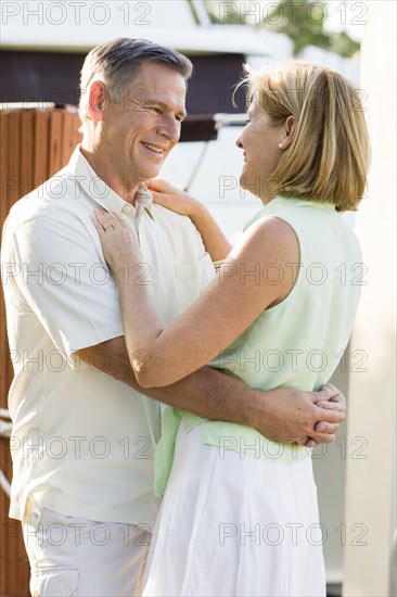 Caucasian couple hugging outdoors