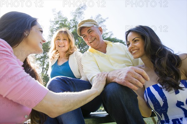Hispanic family relaxing together outdoors