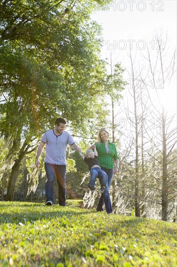 Caucasian family walking in park