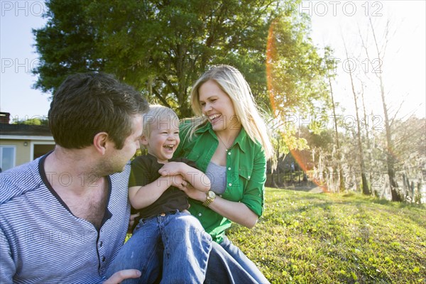 Caucasian family relaxing in backyard