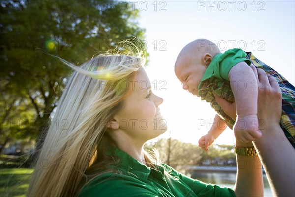 Caucasian woman holding baby outdoors