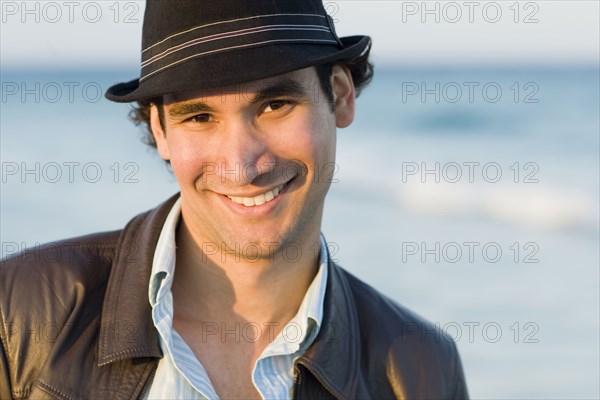 Hispanic man smiling outdoors