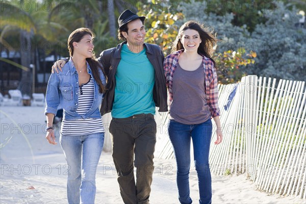 Friends walking on beach