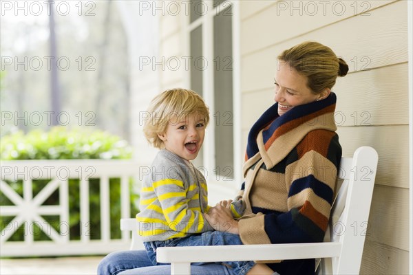 Caucasian mother holding son