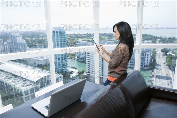 Hispanic businesswoman using digital tablet