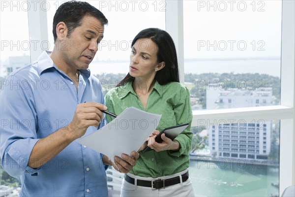 Hispanic business people talking in office