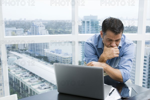 Hispanic businessman working in office