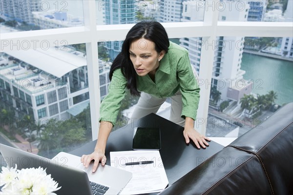 Hispanic businesswoman working in office