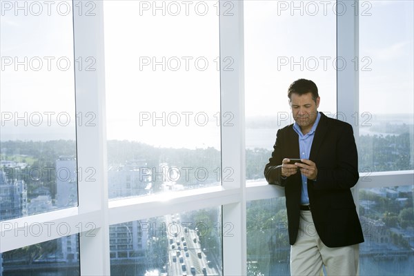 Hispanic businessman using cell phone