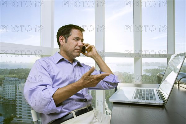 Hispanic businessman talking on cell phone