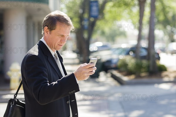 Caucasian businessman using cell phone